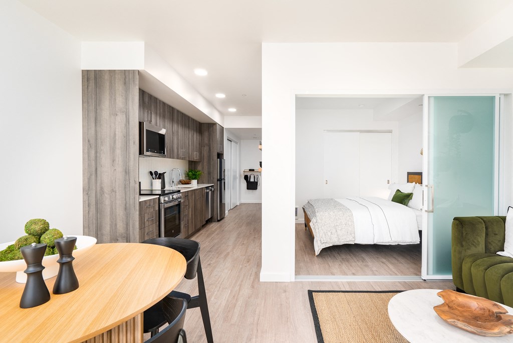 a bedroom with a bed and a desk in a room