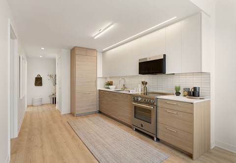 a kitchen with wooden floors and white cabinets