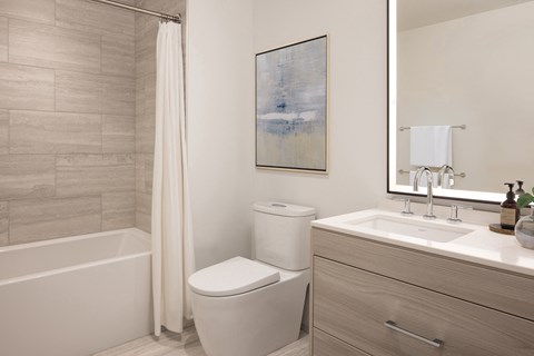 a bathroom with a toilet and a sink and a shower