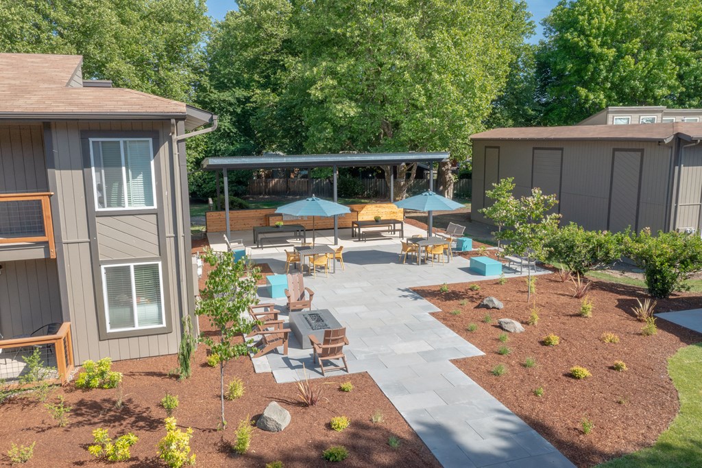 a backyard patio with umbrellas and tables  at Veri at Timberhill, Oregon, 97330