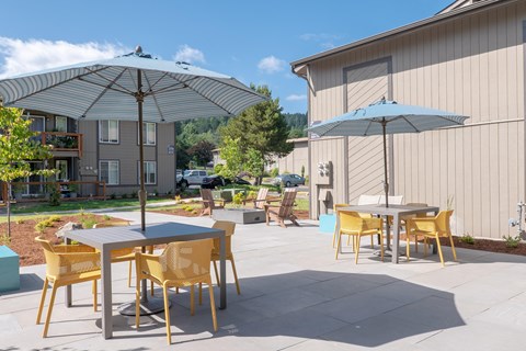 a patio with tables and umbrellas  at Veri at Timberhill, Corvallis, OR