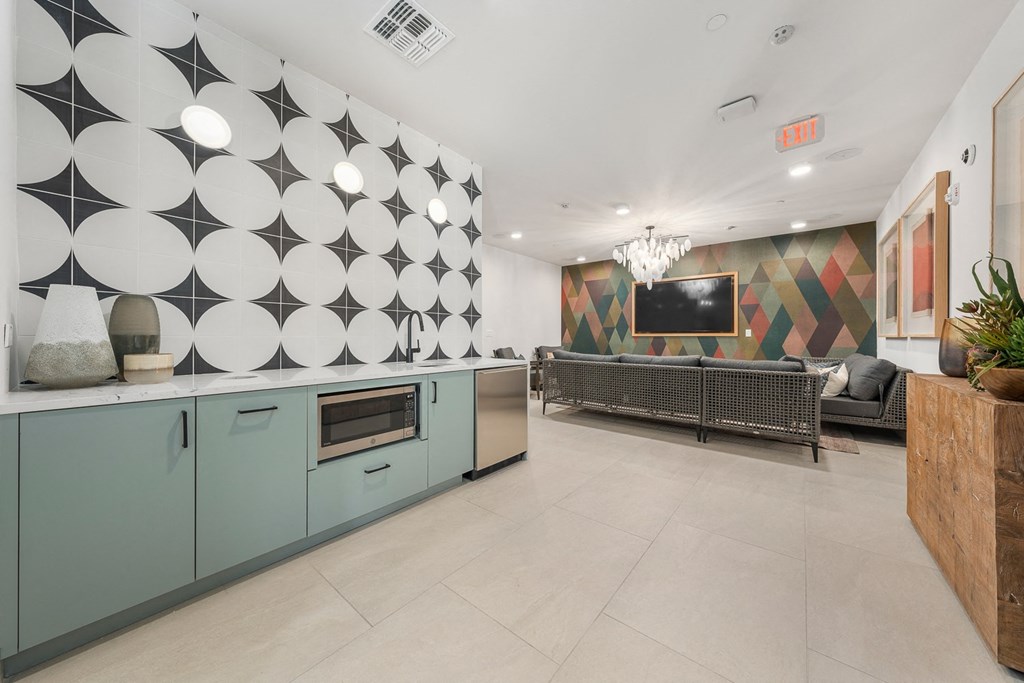the interior of a living room with blue cabinets and a wall with circles on it