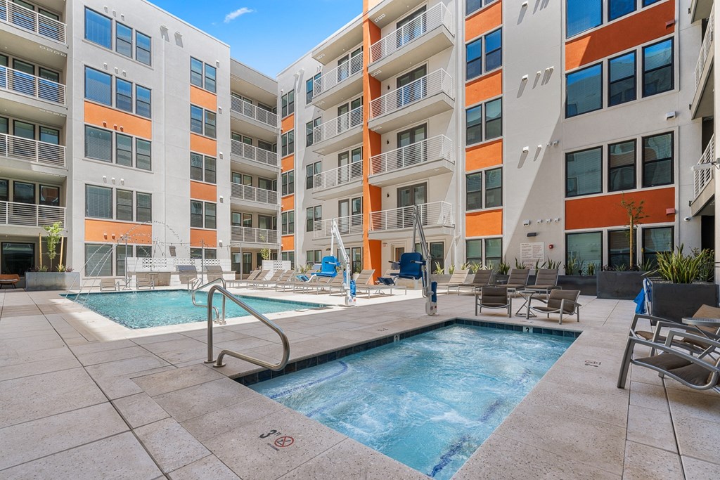 a swimming pool in front of an apartment building