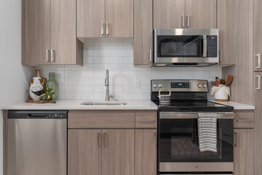 a kitchen with stainless steel appliances and wooden cabinets