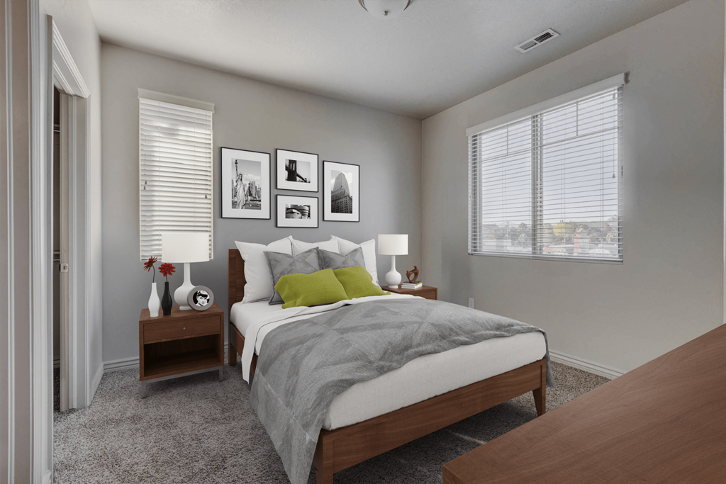 a bedroom with a bed and two nightstands and a window