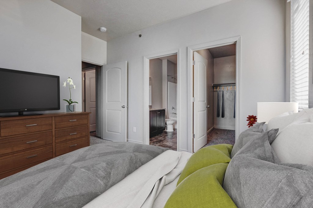 a bedroom with a large bed and a tv