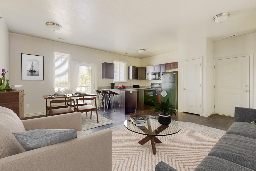 a living room and kitchen with a couch and a table