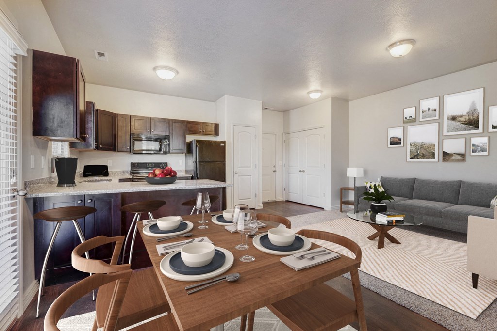 a living room with a dining room table and a kitchen