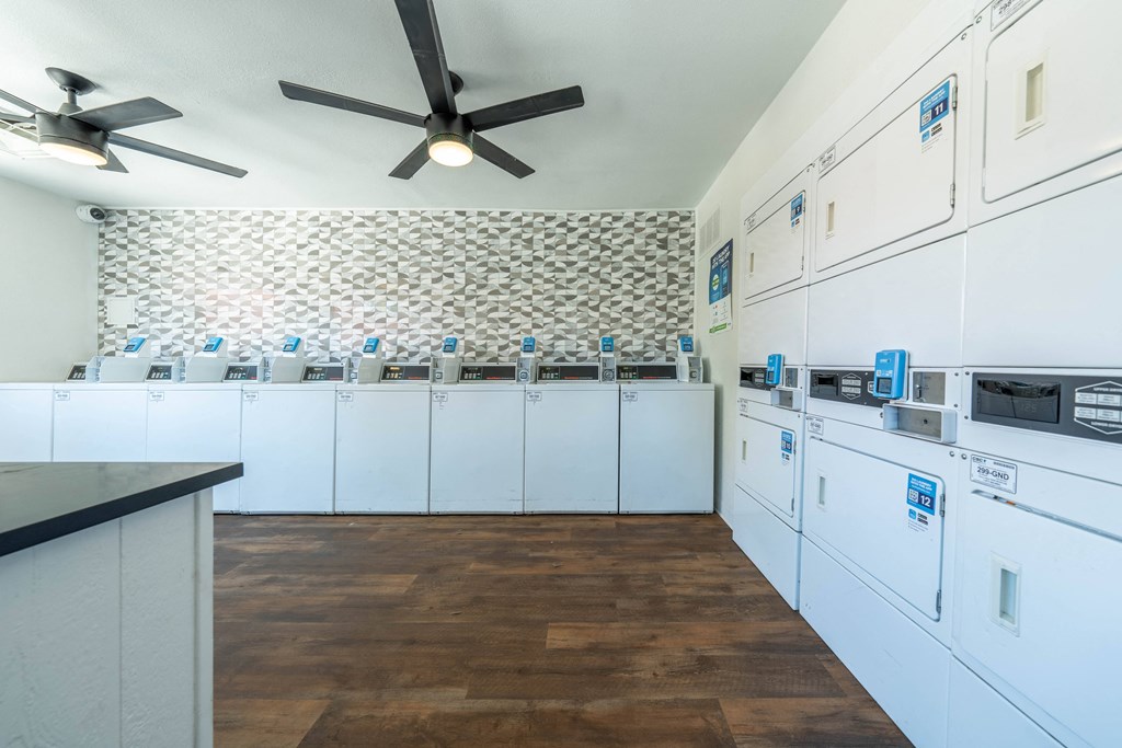 a laundry room with washers and dryers