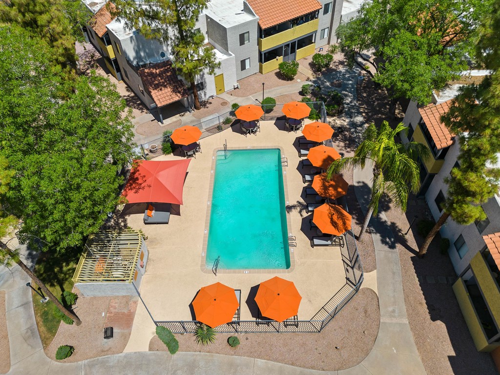 arial view of the resort style pool with orange umbrellas