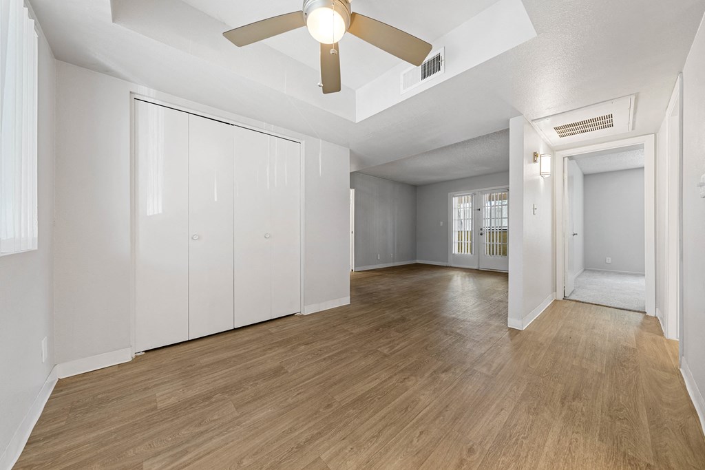 a bedroom with a ceiling fan and a closet
