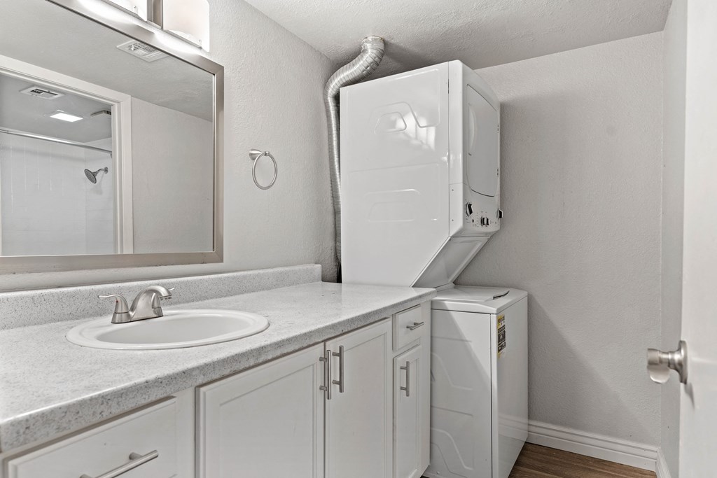 a bathroom with a sink and a washer and dryer