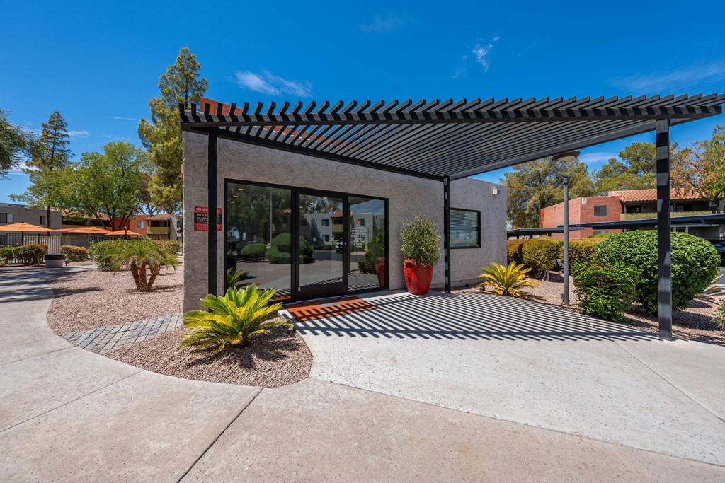 a view of the entrance to the leasing office at the whispering winds apartments in pearland,