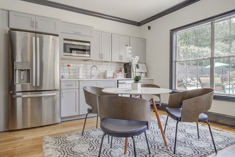 A modern kitchen with a dining table and chairs.