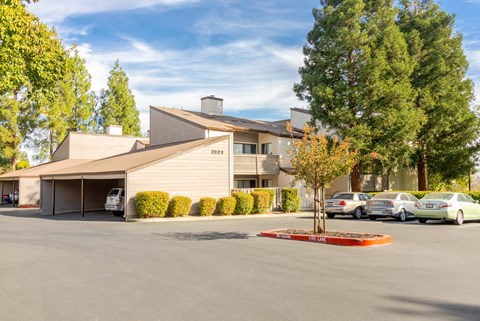 A large building with a parking lot in front of it.