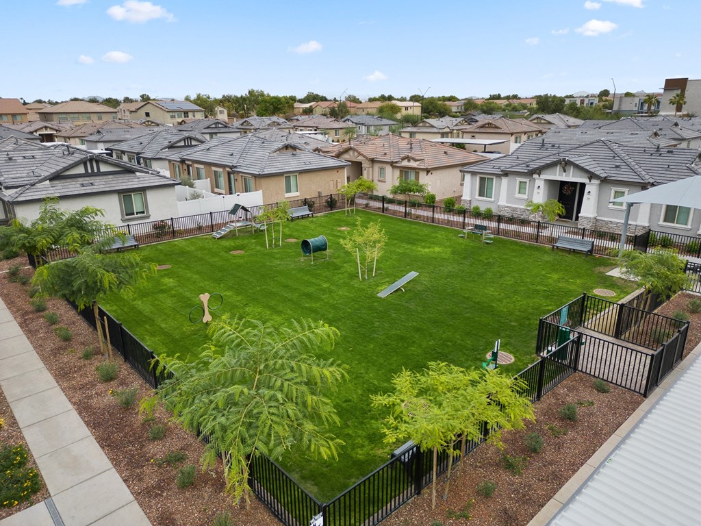 an aerial view of a large bark park with bench and trees