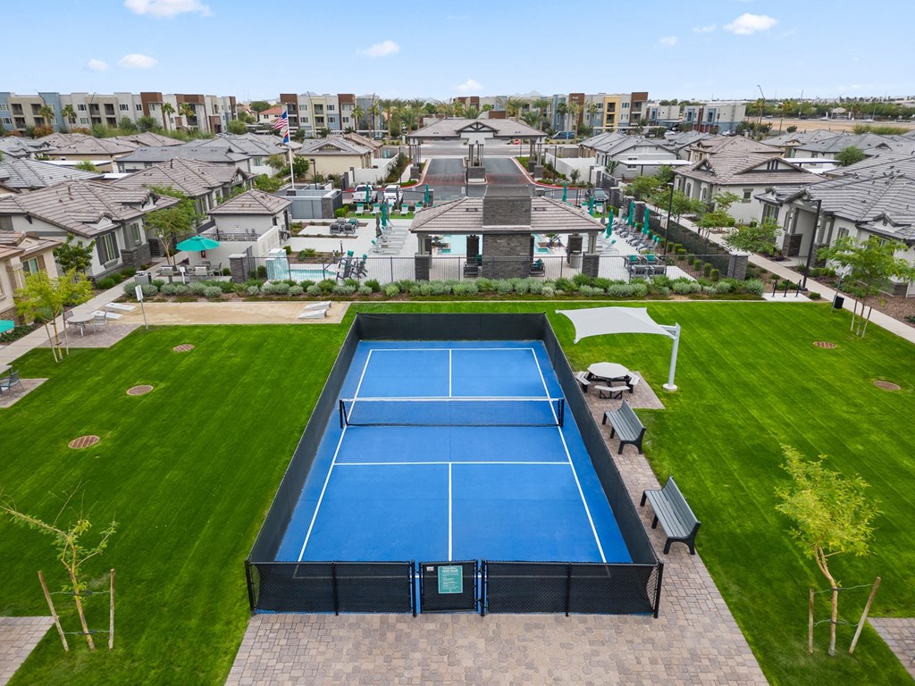 an aerial view of a tennis court with a pool