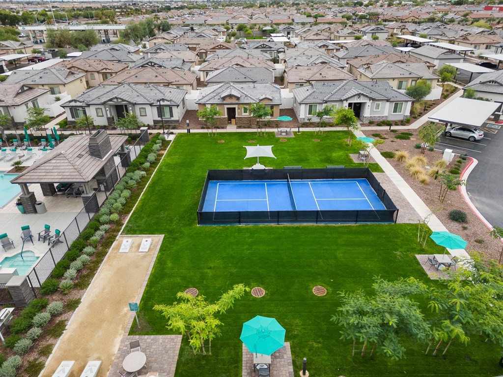an aerial view of community with a tennis court and a pool