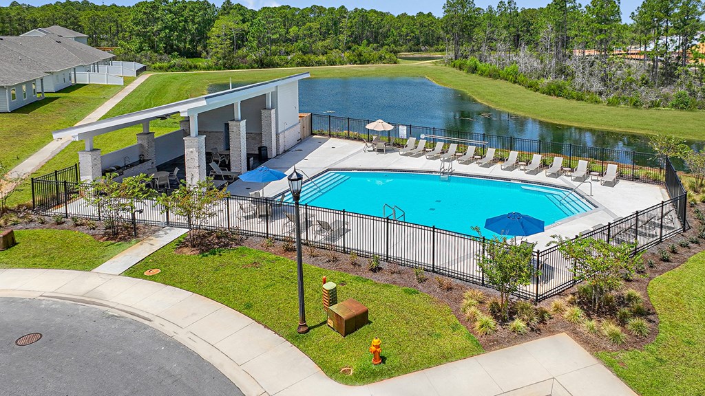 an aerial view of a swimming pool and a building with a resort style pool