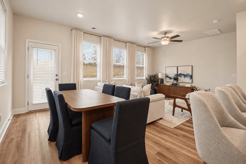 A dining room with a table and chairs.