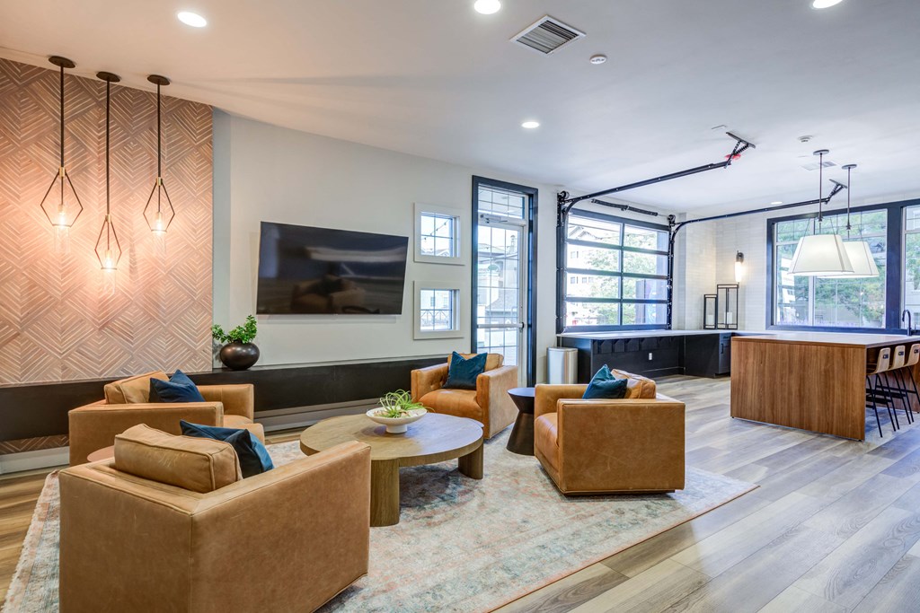 a living room with couches and chairs and a tv