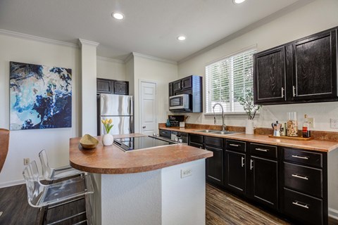a kitchen with black cabinets and a counter top