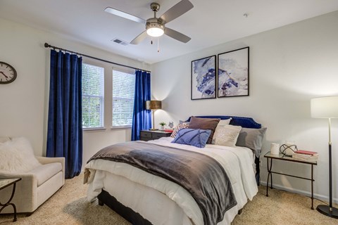 a bedroom with a bed and a ceiling fan