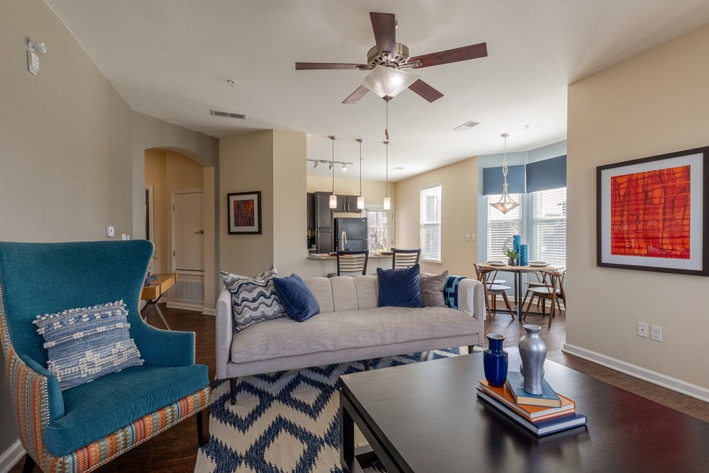 a living room with a ceiling fan and a couch