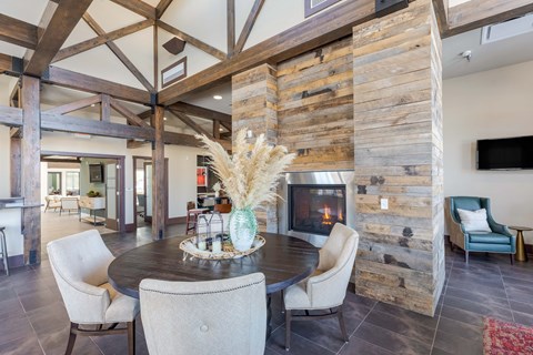 A modern dining room with a wooden table and chairs.