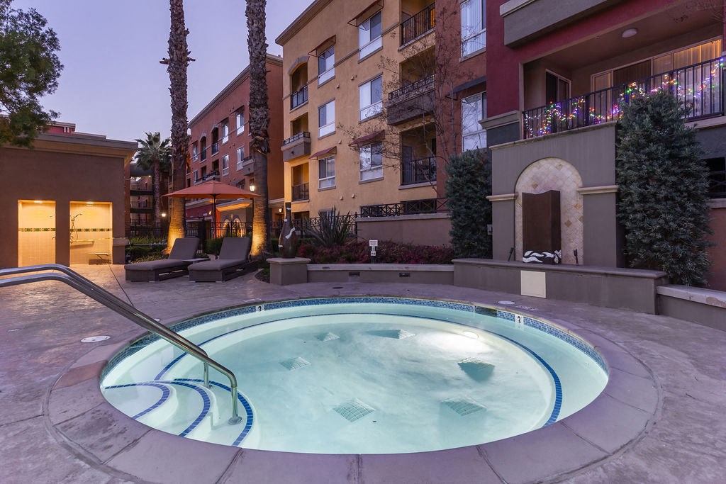 Nighttime shot of spa with buildings in the background.