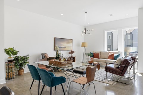 A modern living room with a glass table and chairs.