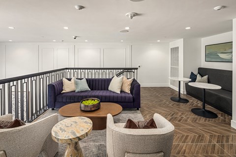 a living room with a purple couch and chairs