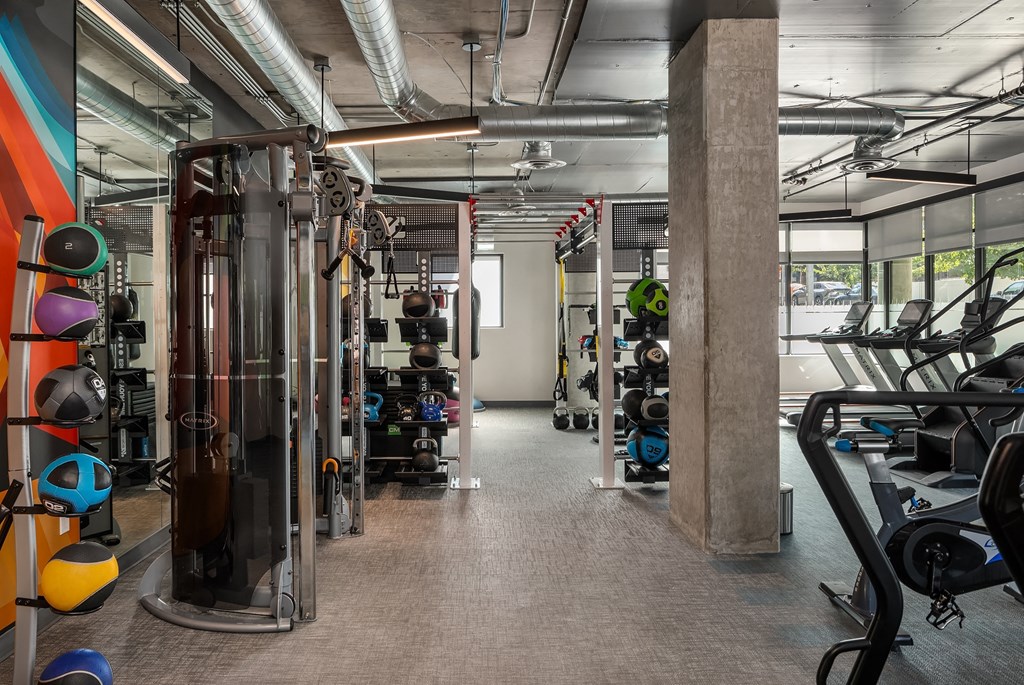 a gym with weights and other exercise equipment in a building