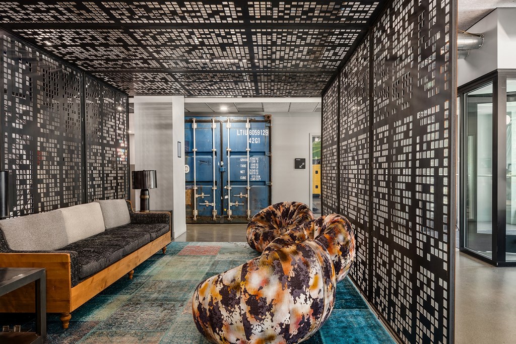 a living room with a couch and a screen in the middle of it