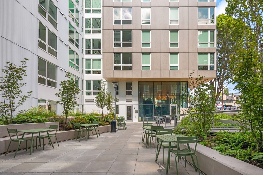 courtyard with tables and chairs in front of an office building