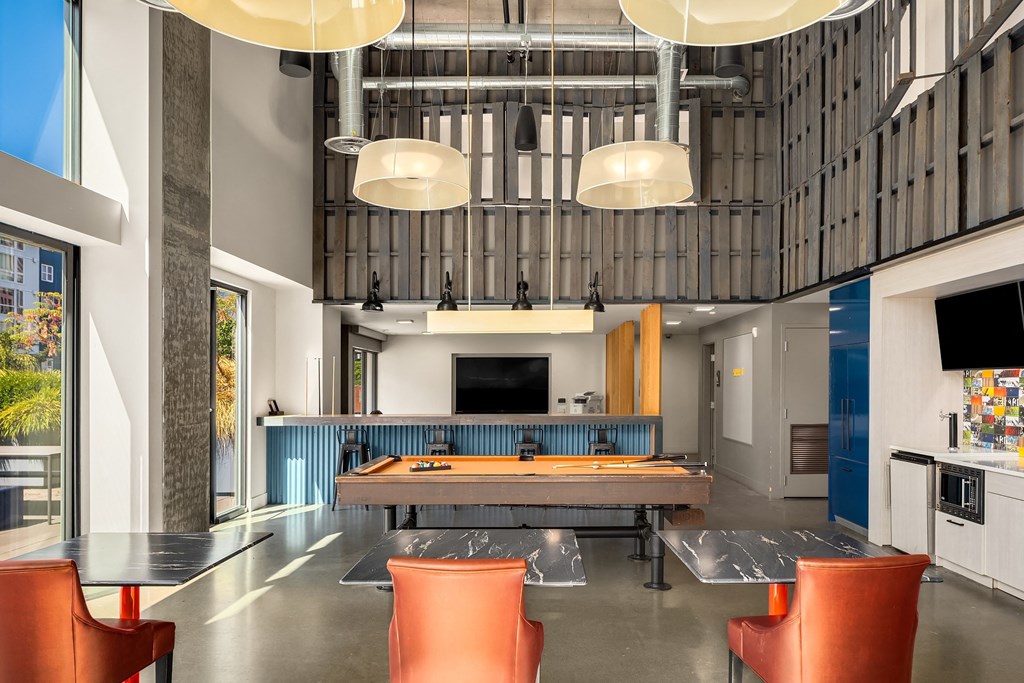 a large conference room with a ping pong table and chairs