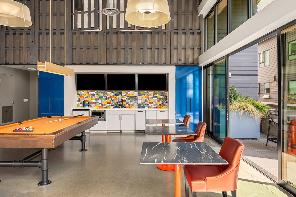 a game room with a pool table and a bar