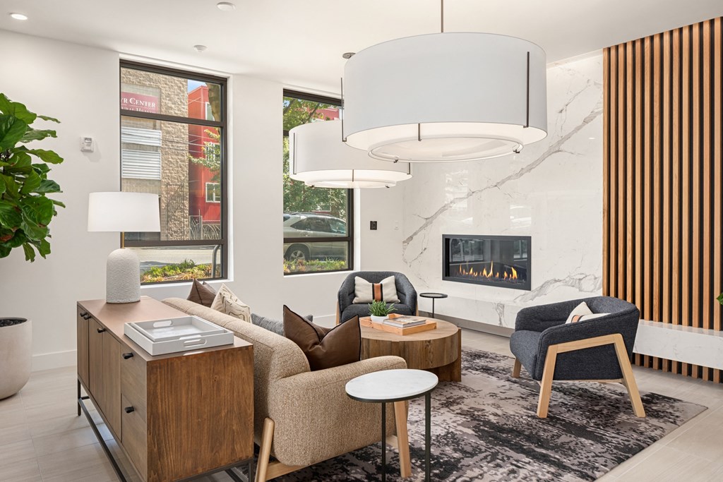 a living room with a couch and chairs and a fireplace