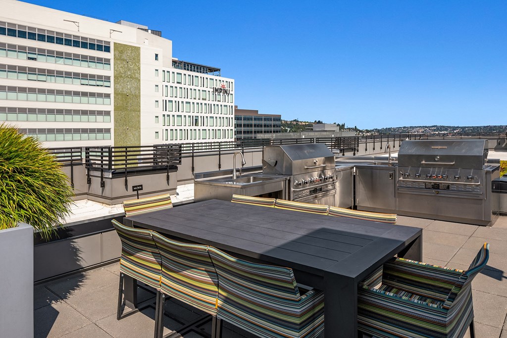 a patio with a table and chairs on a rooftop