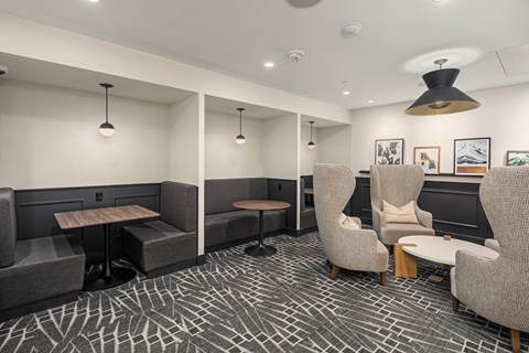 a lounge area with couches chairs and tables and lights