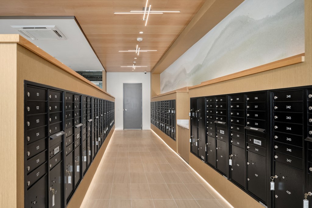 a long row of lockers  in a room with a mural on the wall