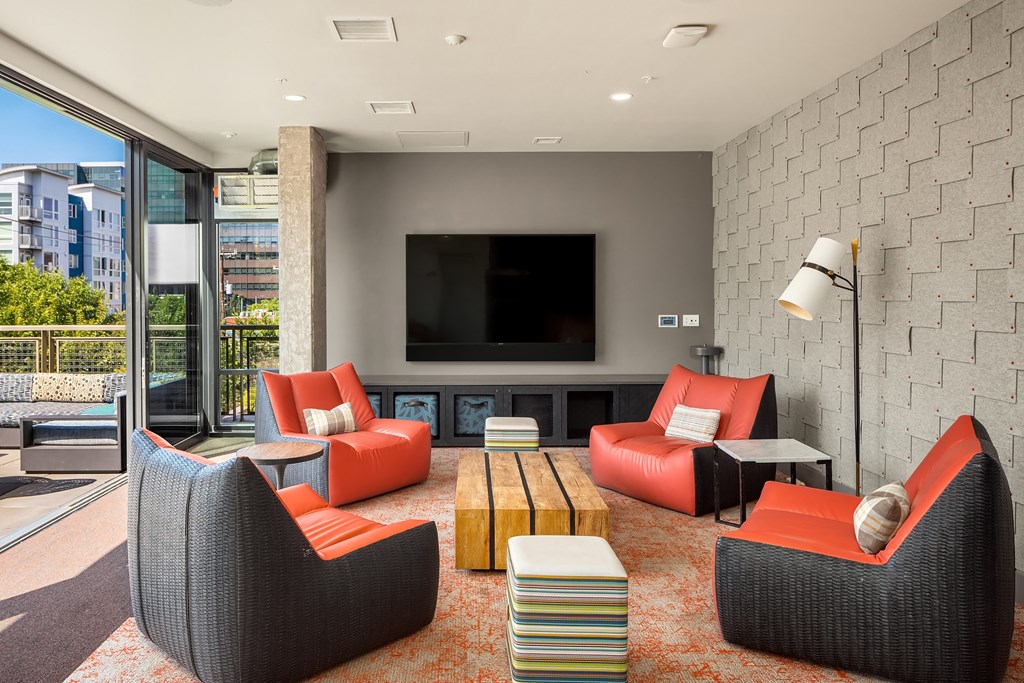 a living room with couches and chairs and a television