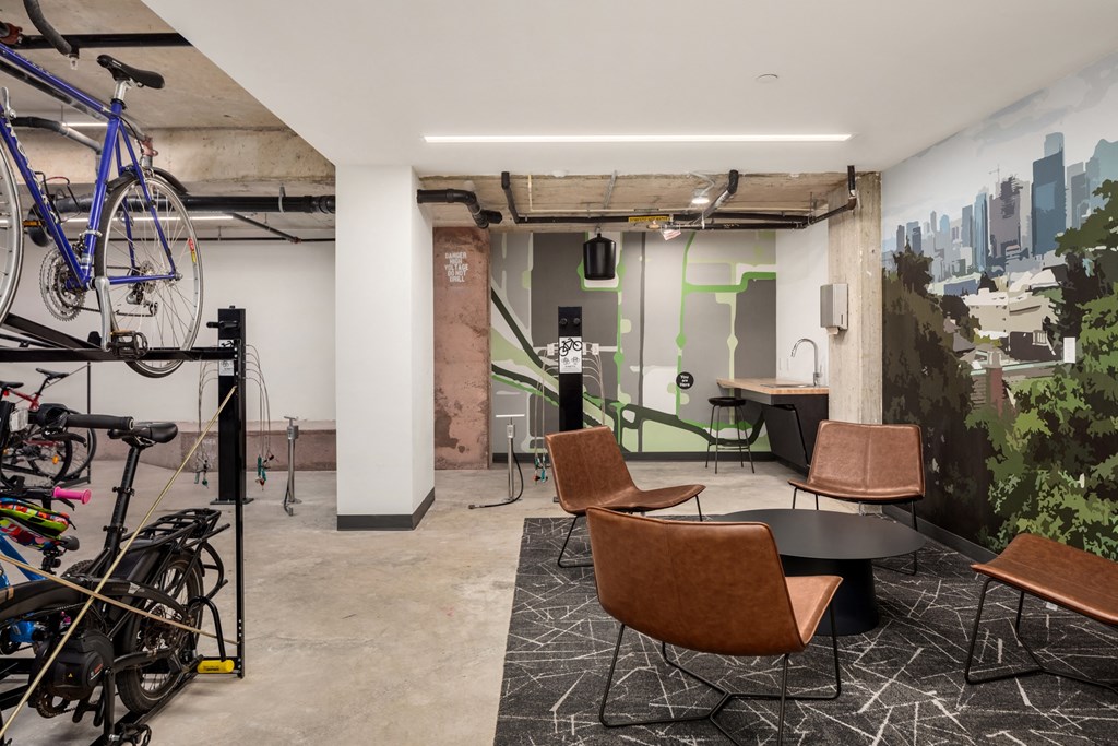 a room with a table and chairs and bikes in it