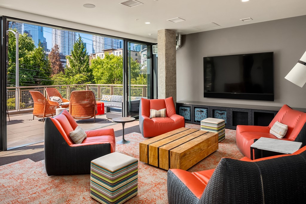 a living room with couches and chairs and a television