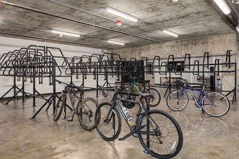 a group of bikes parked in a bike rack in a building