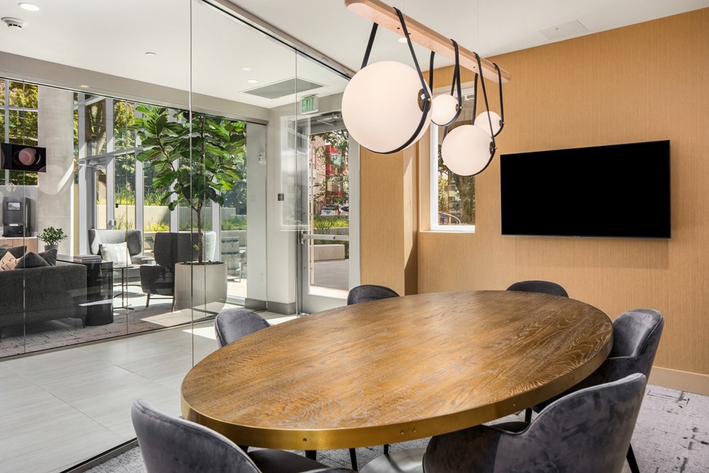 a dining room with a table and chairs and a tv