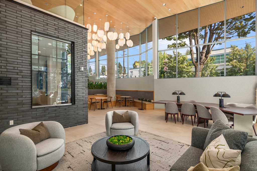 a living room with couches and chairs and a large window