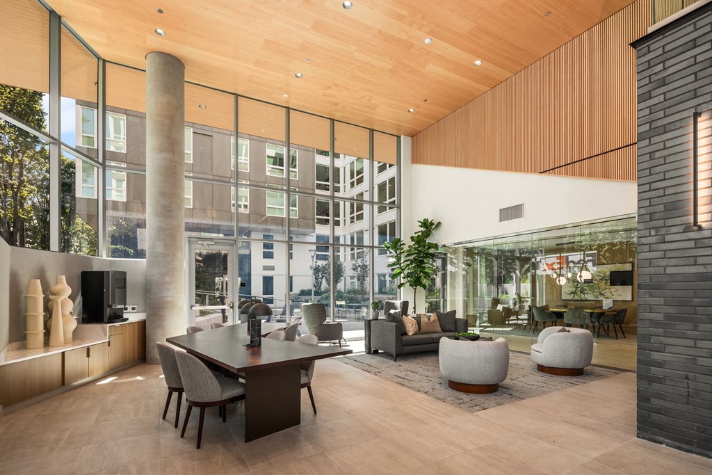 a large living room with a large table and chairs and a large window