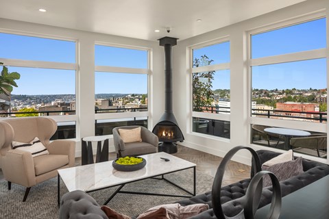 a living room with a fireplace and a view of the city