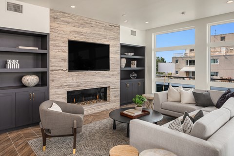 a living room with couches and chairs and a fireplace